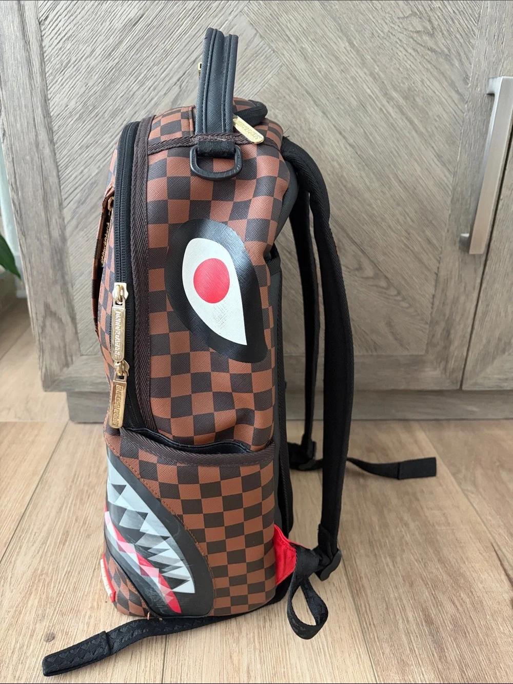 Sprayground Brown Checkerboard Backpack with Red & White Shark Mouth